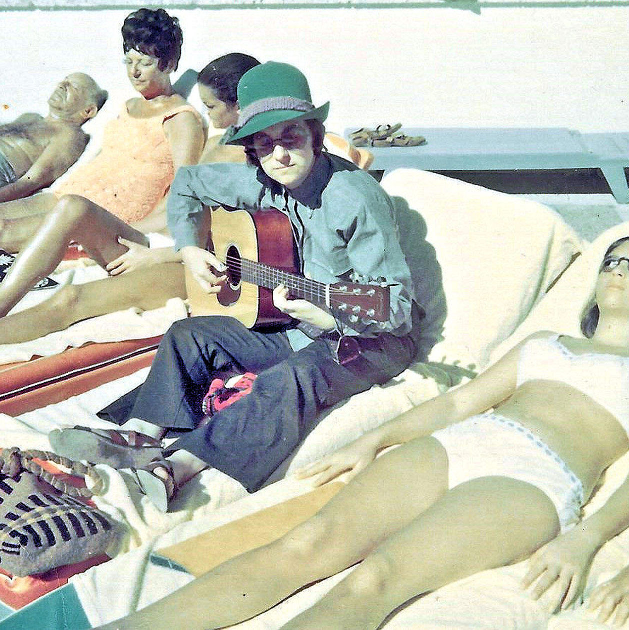 The author playing her Martin D-18 on a beach